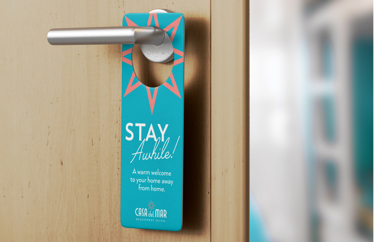 Showing a hang tag created by MDR on a hotel door with the inscription "Stay awhile! A warm welcome to your home away from home."