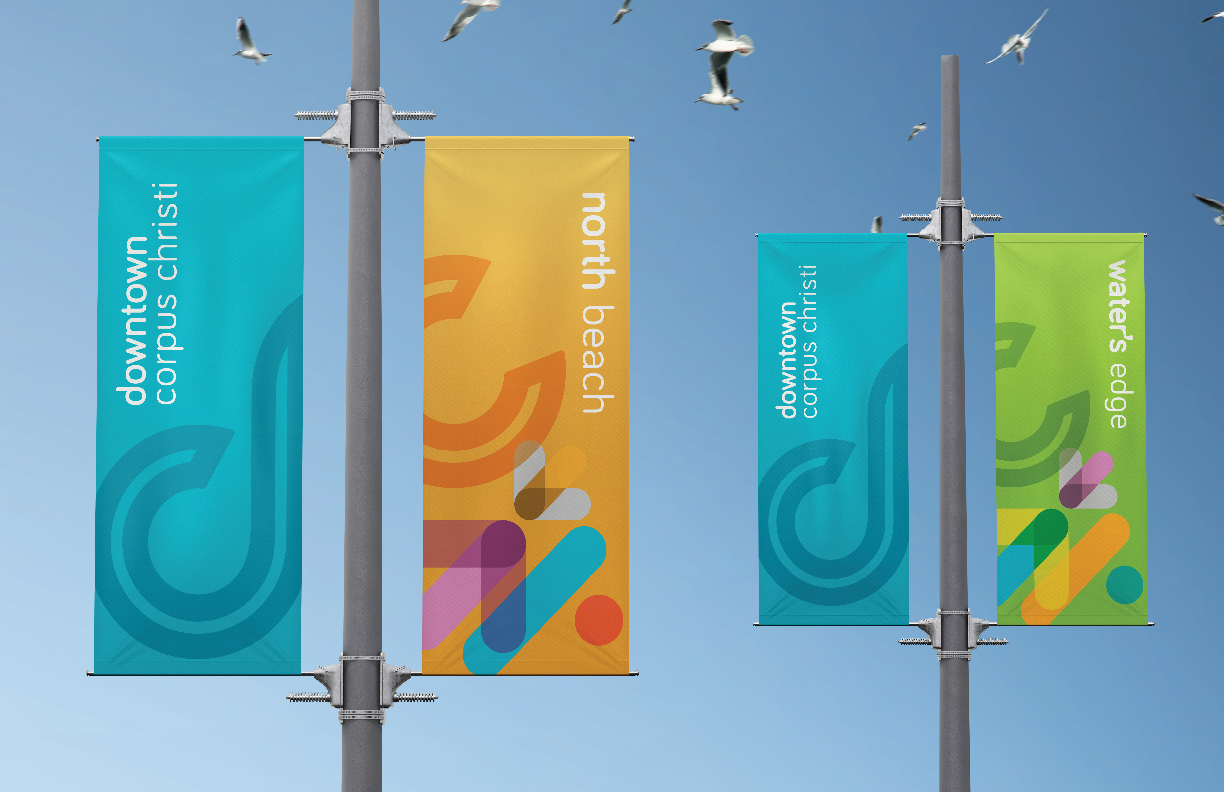 Showing light poles with banners that feature Downtown Corpus Christi branding.