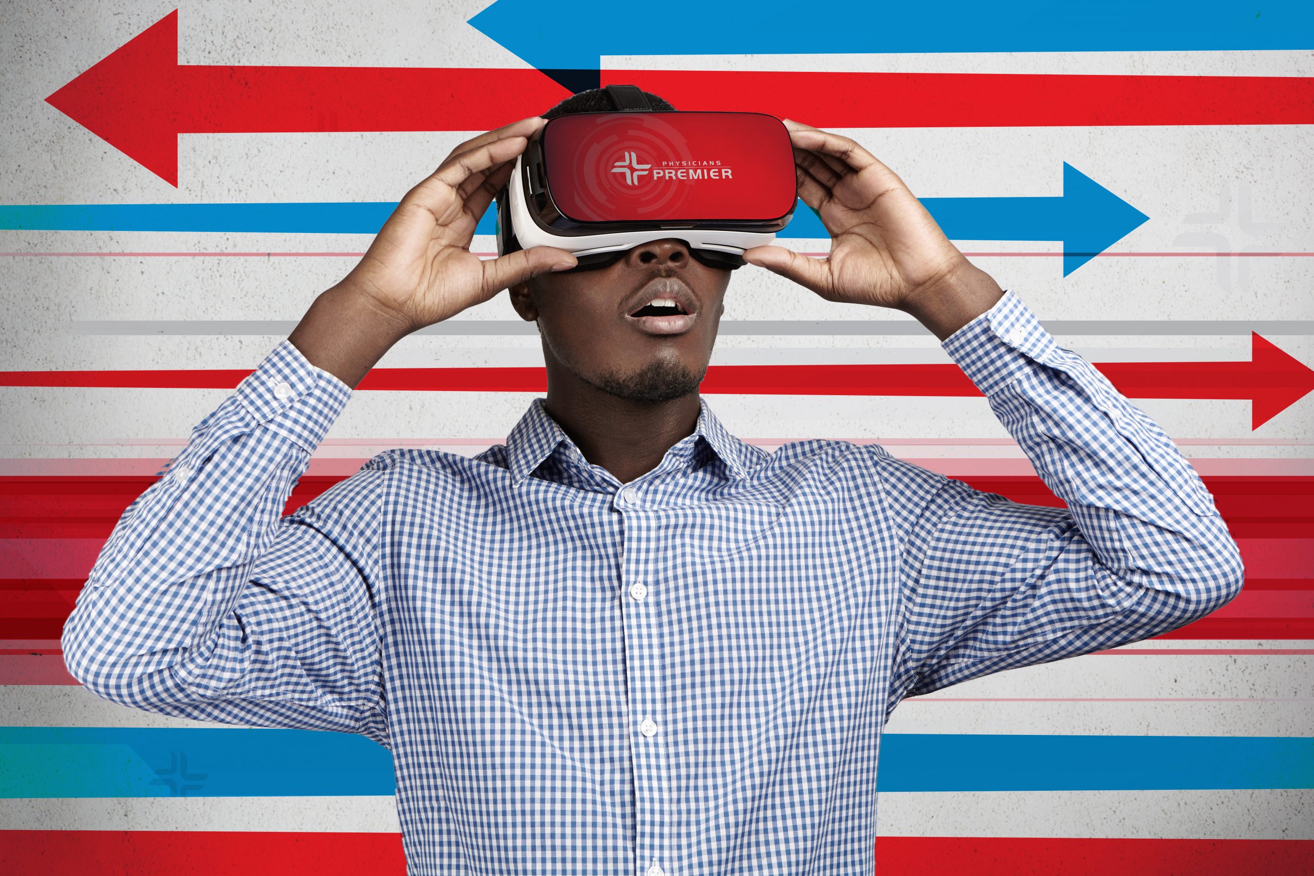 People, technology, innovation and gaming concept. Astonished African businessman in checkered shirt experiencing virtual reality while using oculus rift headset for entertaining himself in office